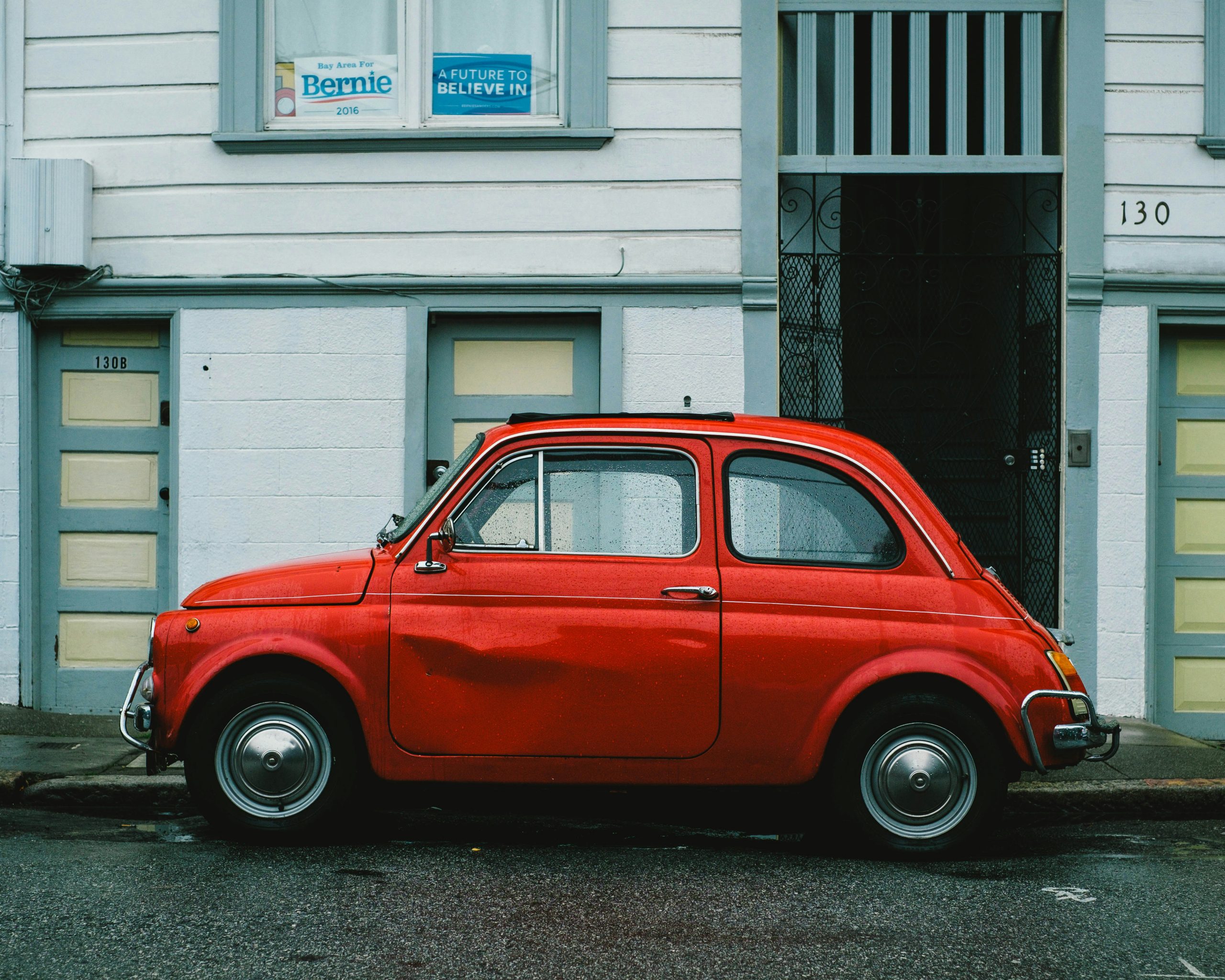 red car with a door dent